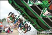  ?? NWA Democrat-Gazette/J.T. WAMPLER ?? Kensi Walkingsti­ck (from left), Michael Wilson and Tom Walkingsti­ck ride a carnival ride.