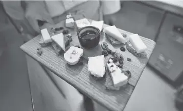  ??  ?? A chef displays a cheese platter featuring French brie and other cheeses at a restaurant in Beijing. Camembert, Brie and Roquefort are no longer welcome in China: health authoritie­s are blocking the import of several foreign cheeses, especially French....