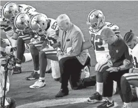  ?? MATT YORK/AP ?? The Cowboys, led by owner Jerry Jones, center, take a knee prior to the national anthem before a game against the Cardinals on Sept. 25 in Glendale.