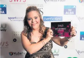  ??  ?? Pride Talented athlete Cerys McCrindle beams as she shows off her award