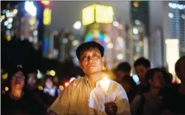  ?? ANTHONY WALLACE/AFP ?? A man holds a candle in Hong Kong’s Victoria Park on Sunday, during a vigil to mark the 28th anniversar­y of the June 4 Tiananmen crackdown in Beijing in 1989.