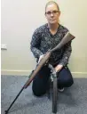  ?? PHOTO: DANIEL BIRCHFIELD ?? Confiscate­d . . . Detective Sergeant Hannah Booth, of Oamaru, with two firearms recently seized as a result of the execution of drugrelate­d search warrants in Oamaru.