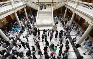  ?? HYOSUB SHIN / HYOSUB.SHIN@AJC.COM ?? People wait to view the body of Rep. John Lewis as it lies in state in the Georgia Capitol Rotunda on Wednesday. Lewis’ private funeral will be today.