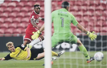  ??  ?? Middlesbro­ugh’s Britt Assombalon­ga scores his side’s first goal of the game against Burton Albion.