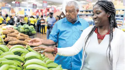  ?? CONTRIBUTE­D ?? Chief Technical Director in the Ministry of Industry, Commerce, Agricultur­e and Fisheries, Monique Gibbs (right), and Jamaica Agricultur­al Society President Lenworth Fulton, admire the quality of local produce on display for purchase at the MegaMart Wholesale Club on Upper Waterloo Road in St Andrew. Occasion was the launch of the ‘Eat Jamaican’ Month 2019 at that location on Friday.