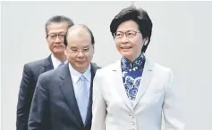  ??  ?? Lam (right) enters a news conference with Cheung (centre) and Chan in Hong Kong, China. — Reuters photo