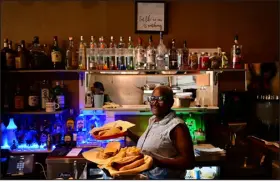  ?? HELEN H. RICHARDSON — THE DENVER POST ?? Owner Leola Gant serves lunch to customers at Blazing Chicken Shack II on Oct. 4, 2022, in Denver.