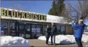  ?? GILLIAN FLACCUS—ASSOCIATED PRESS ?? Debby Saltzman, of Bend, Ore., poses for a photo on Monday, March 11, 2019, in front of the last Blockbuste­r store on the planet with her twin brother, Michael Trovato. Trovato was visiting from Melbourne, Australia, where he lives. Taking the photo is Saltzman’s husband, Jeremy Saltzman. When a Blockbuste­r in Perth, Australia, shuts its doors for the last time on March 31, the store in Bend, Ore., will be the only one left on Earth, and most likely in the universe.