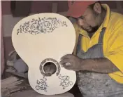  ?? — AFP ?? Mexican luthier Salvador Meza makes a replica guitar.