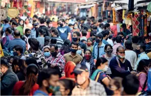  ?? ANI ?? NO SOCIAL DISTANCING: People throng Sarojini Nagar market in New Delhi for shopping on the eve of Diwali on Friday. —