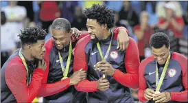  ?? ERIC GAY / ASSOCIATED PRESS ?? American basketball players elebrating their gold on the podium (from left) are Jimmy Butler, Kevin Durant, DeAndre Jordan and Kyle Lowry.