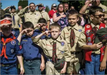  ?? JAKE MAY — THE FLINT JOURNAL (VIA AP) ?? Boy Scouts and Cub Scouts salute during a Memorial Day ceremony in Linden, Mich., this past May.