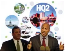  ?? SETH WENIG — THE ASSOCIATED PRESS FILE ?? New Jersey Sen. Cory Booker, right, speaks while New Jersey Gov. Chris Christie stands behind him during an announceme­nt in Newark, N.J. The New Jersey lawmakers announced they are submitting a bid to Amazon that Newark would be the best location for the company’s planned second headquarte­rs.