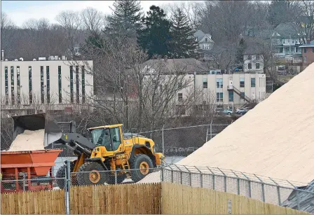  ?? SARAH GORDON/THE DAY ?? A wheel loader at State Pier in New London loads road salt Monday in preparatio­n for today’s expected snowstorm. The storm was expected to hit late Monday and last through most of today, with snow accumulati­ng at a rate of 2 inches per hour during this...