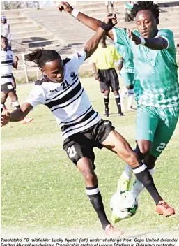  ??  ?? Tsholotsho FC midfielder Lucky Nyathi (left) under challenge from Caps United defender Carlton Munzabwa during a Premiershi­p match at Luveve Stadium in Bulawayo yesterday
