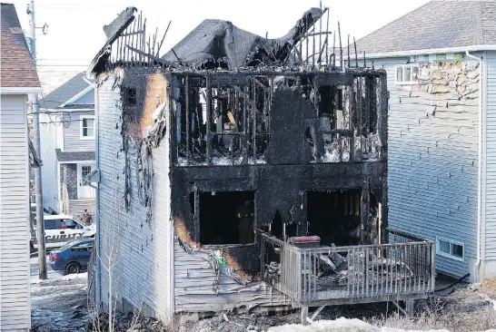 ?? TED PRITCHARD / REUTERS ?? Neighbours reported hearing a loud bang followed by screams as fire raced through a suburban Halifax home overnight Tuesday, killing seven children.