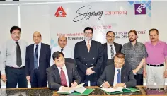  ??  ?? MIPL CEO Raafey Zaman Durrani and IFS Pakistan Country Director Poorna Bandara signing contract. Standing from left: Khuram Toor, Col.(r) Javid Aslam, Mian Muhammad Saleem, Millat Chairman Sikandar Mustafa Khan, Shiraz Lye, Laeeq Uddin Ansai and Khalid Latif Hashmi