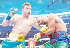  ??  ?? Saul “Canelo” Alvarez (left) throws a jab at Billy Joe Saunders during their fight.