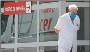  ?? (AP/Eraldo Peres) ?? A doctor gets some fresh air as he takes a walk outside the HRAN Hospital in Brasilia, Brazil.