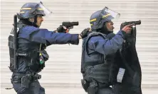  ?? Francois Mori / Associated Press ?? Officers operate in St.-Denis, a suburb of Paris where police engaged in a blistering gunbattle with suspected militants.