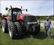  ??  ?? “These things aren’t Porsches; the steering is not refined,” says farmer Dave Wolfskill, who demonstrat­ed with his Case-IH tractor and corn planter during Rural Roads Safety Week. Near-collisions and side-swipes are common.