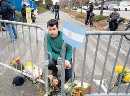  ?? CAROLYN COLE/LOS ANGELES TIMES ?? George Embiricos, 27, leaves flowers at the bike path along West Street in Manhattan in commemorat­ion of those killed in Tuesday’s terror attack. “I walk the path every day. It’s been a source of peace for me. It’s hard to see the city where I grew up...