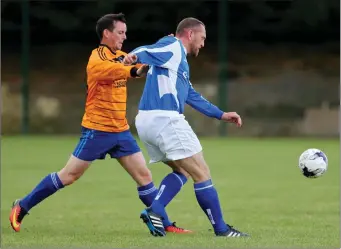  ??  ?? Kieran Kelly of Taghmon United wins this duel with Raheen’s Shane Whelan.