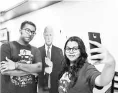  ??  ?? Bangladesh­i customers take selfie with a cutout Donald Trump at the Trump Cafe in Dhaka. — AFP photo