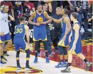  ?? RON SCHWANE/ASSOCIATED PRESS ?? Golden State’s Kevin Durant (35) celebrates with his teammates after the Warriors beat the Cavaliers to grab a 3-0 lead in their FInals series. No team has ever recovered from such a deficit to win an NBA series.