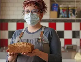  ?? Steve Mellon/Post-Gazette photos ?? Meghann Walsh with Irish brown bread she made in the kitchen of her bakery in Scott. She likes to eat it with salted butter and honey.