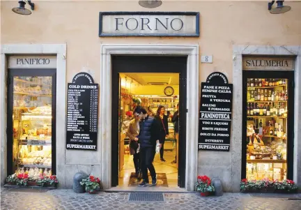  ?? (Tony Gentile/Reuters) ?? A PLACARD showing prices is displayed outside a bakery in downtown Rome last week. With the possibilit­y of an election by June, politician­s of all stripes are tapping into growing hostility toward the euro. Many Italians hold the single currency...