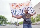  ?? JOSH MORGAN/USA TODAY ?? Nadine Seiler demonstrat­es outside court in Washington as Donald Trump appeared to face federal charges in August.