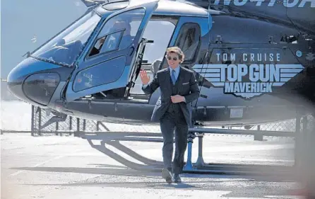  ?? ROBYN BECK/GETTY ?? Tom Cruise arrives in a helicopter to the world premiere of “Top Gun: Maverick” aboard the USS Midway in San Diego, California, on May 4.