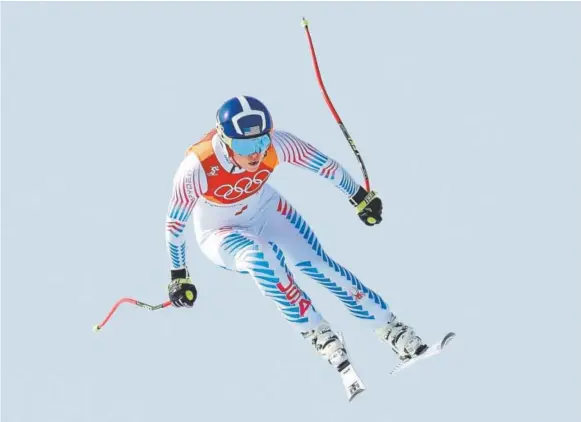 ?? Alexander Hassenstei­n, Getty Images ?? Lindsey Vonn competes in the downhill Wednesday at Jeongseon Alpine Centre. She earned the bronze medal in what she called her final Olympic run of her best event. Sofia Goggia of Italy won the gold medal, 0.47 of a second ahead of Vonn and 0.09 of a...