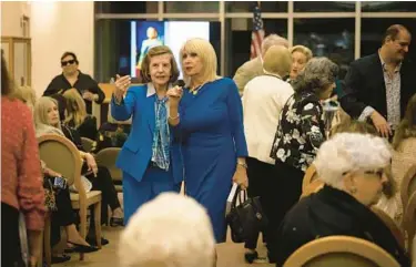  ?? ALIE SKOWRONSKI/MIAMI HERALD ?? Arnhilda Badía, left, speaks Jan. 25 with Mari Tere Rojas, chair of the Miami-Dade School Board, before a panel discussion with women featured in Badía’s book at the Otto G. Richter Library at the University of Miami.