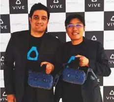  ?? Naushad K. Cherrayil/Gulf News ?? Ramit Harisingha­ni and Raymond Pao with the Vive Pro. HTC launched its VR headset — Vive Pro — in Dubai on Wednesday.