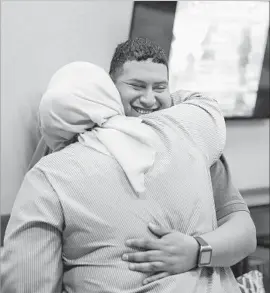  ?? Todd Spoth For The Times ?? ARMANDO SEGURA, a new member, hugs his sister after a ceremony welcoming him to Centro Islámico. Houston is home to more than 1,000 Latino Muslims.