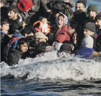  ?? ARIS MESSINIS/ GETTY IMAGES ?? Refugees and migrants arrive on Lesbos Monday after crossing from Turkey. The island’s mayor said authoritie­s are working to find burial locations for dozens of bodies in the morgue.