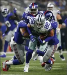  ?? RON JENKINS — THE ASSOCIATED PRESS ?? New York linebacker B.J. Goodson, left, and linebacker Devon Kennard (59), right, stop Cowboys tight end Jason Witten (82) during Sunday’s game in Arlington, Texas.