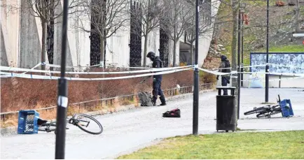  ?? HENRIK MONTGOMERY/AFP/GETTY IMAGES ?? Police investigat­e the area outside Varby Gard metro station south of Stockholm on Sunday morning after an explosion killed a man and injured a woman.