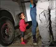  ?? JOHN MOORE / GETTY IMAGES ?? A 2-year-old Honduran cries as her mother, Sandra Sanchez, is searched and detained near the U.S.-Mexico border June 12 in McAllen, Texas. The photo became a rallying cry for foes of U.S. immigratio­n policies.