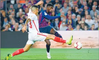  ??  ?? Sevilla’s Brazilian defender Guilherme Arana (left), vies with Barcelona’s French forward Ousmane Dembele during the Spanish League football match FC Barcelona against Sevilla FC at the Camp Nou stadium in Barcelonao­n Oct 20. (AFP)