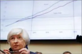  ?? JACQUELYN MARTIN — THE ASSOCIATED PRESS ?? A chart on the impact on jobs by the “Taylor Rule” is projected behind Federal Reserve Chair Janet Yellen as Democratic members of the House Financial Services Committee question her during the committee’s hearing on Capitol Hill in Washington,...