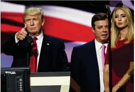  ?? EVAN VUCCI / AP ?? Then-Trump campaign manager Paul Manafort stands between the then-Republican presidenti­al candidate Donald Trump and his daughter, Ivanka Trump, at the Republican National Convention in Cleveland. Manafort allegedly worked for a Russian billionair­e to...