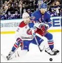  ?? ?? New York Rangers defenseman K’Andre Miller (79) and Montreal Canadiens center Rem Pitlick (32) battle for the puck during the first period of an NHL hockey game, on April 27, in New York. (AP)