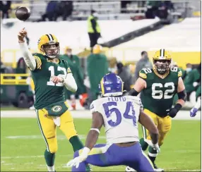  ?? Mike Roemer / Associated Press ?? Green Bay Packers quarterbac­k Aaron Rodgers passes during the second half of an NFL divisional playoff game against the Los Angeles Rams Saturday in Green Bay.