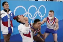  ?? GREGORY BULL — THE ASSOCIATED PRESS ?? Russian Olympic Committee’s artistic gymnastics men’s team, from right, Denis Abliazin, right, Nikita Nagornyy, David Belyavskiy and Artur Dalaloyan celebrate after winning the gold medal Monday at the 2020 Summer Olympics.