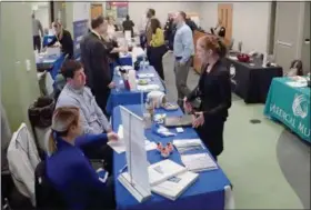  ?? JONATHAN TRESSLER — THE NEWS-HERALD ?? Attendees at Lakeland’s most recent job fair interact with dozens of Northeast Ohio employers in this March 27 photo.