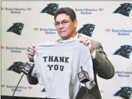  ?? David T. Foster III / TNS ?? Former Panthers head coach Ron Rivera holds up a Tshirt at the end of a press conference at Bank of America Stadium on Dec. 4. The Redskins have hired Rivera as their head coach.