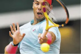  ?? (Photos: AFP) ?? Spain’s Rafael Nadal returns the ball to Mackenzie Mcdonald of the US during their men’s singles second-round tennis match on day four of The Roland Garros 2020 French Open tennis tournament in Paris, yesterday.